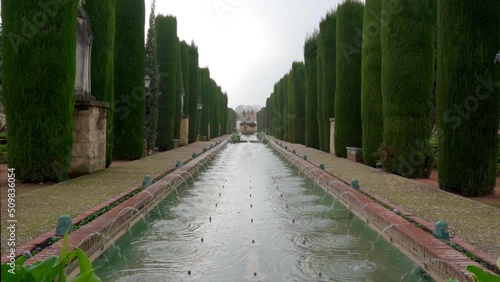 Pan up on Castle of the Christian Monarchs Garden Fountain on Cloudy Day photo