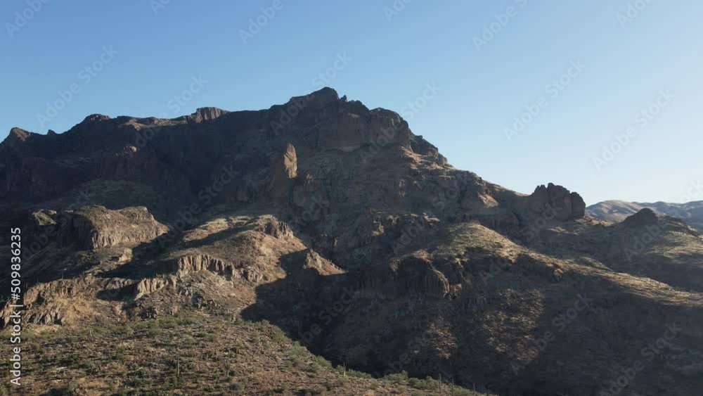 A drone pushes forward over the ridgeline of the Superstition Mountain.