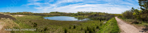 Panoramic shot of the dune landscape near Egmond aan Zee Netherlands with a water pond