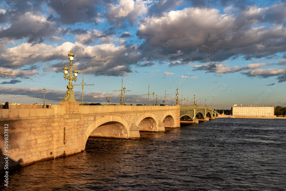 Trinity Bridge in St. Petersburg at sunset. Road metal drawbridge across the Neva River in St. Petersburg.
