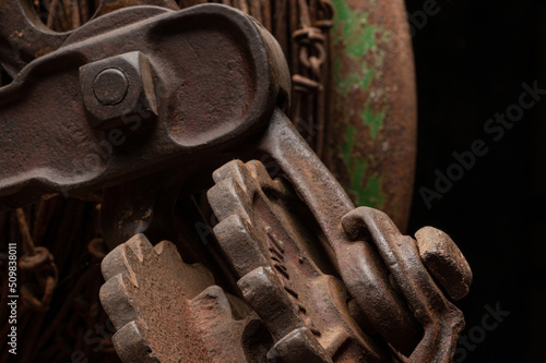 Rusty wire, john deere green patina with metal gears and close up macro of rusty steel bolts and paint