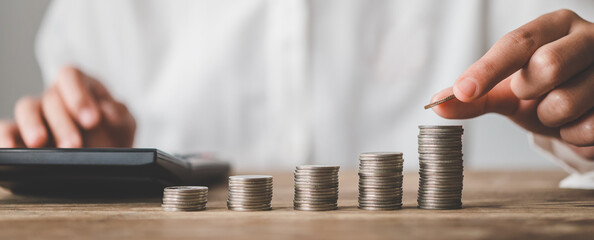  Hand putting money coin on each line rising - business saving money concept  for finance accounting