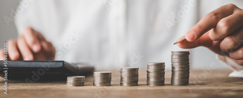  Hand putting money coin on each line rising - business saving money concept  for finance accounting