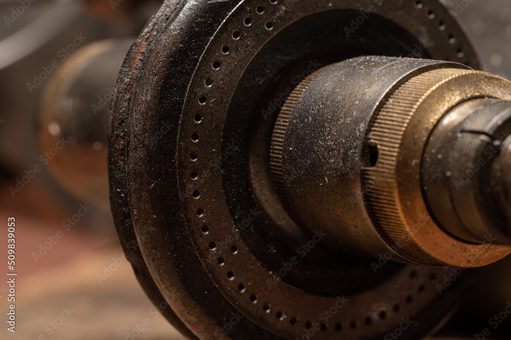 Close up details of metal lathe handle and gears, beautiful patina and age.