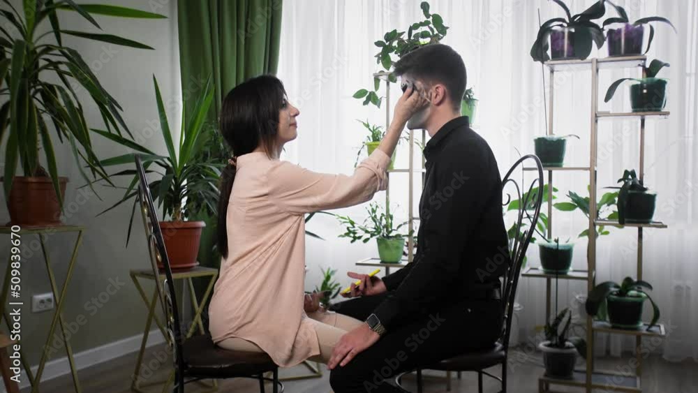 A young woman is preparing makeup for Halloween. Create a Halloween look A young woman is preparing makeup for Halloween. Create a Halloween look
