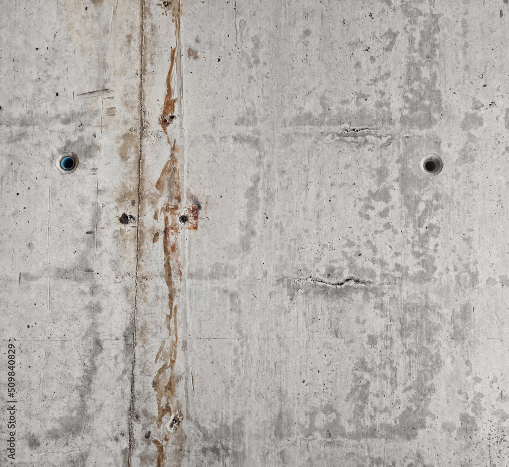 smooth raw concrete wall with concrete form dimples, grid lines and brown rusty on its texture. cement stone texture background. gray concrete texture with dirty stripes along. smooth raw concrete wall with concrete form dimples, grid lines and brown rusty on its texture. cement stone texture background. gray concrete texture with dirty stripes along.
