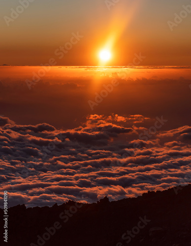 Sunset above the colorful clouds on the peak of Mount Teide called 'Pico del Teide'. Teide National Park, Tenerife, Canary islands, Spain.