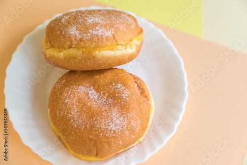 Bolas de Berlim, Berliner or donuts filled with egg jam. A very popular dessert in Portuguese pastry shops. photo