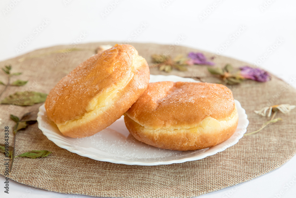 Bolas de Berlim, Berliner or donuts filled with egg jam, a very popular dessert in Portuguese pastry shops. Bolas de Berlim, Berliner or donuts filled with egg jam, a very popular dessert in Portuguese pastry shops.