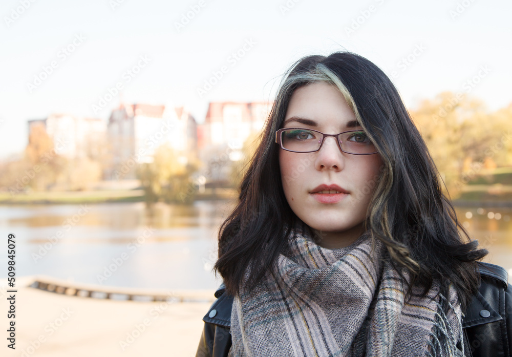 portrait of  young girl in city park on an autumn day