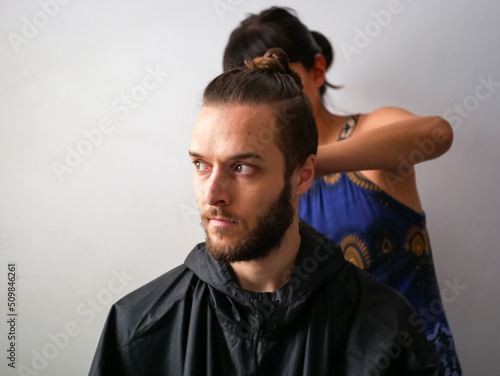 Young White Male with Beard get a Hair Cut by a a Young Woman