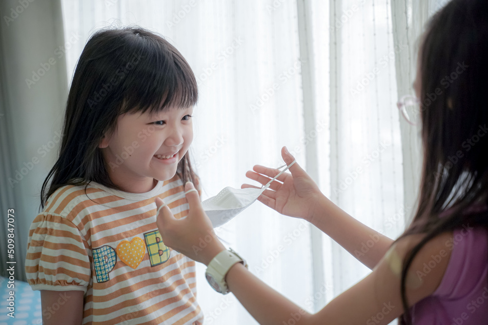 Coronavirus Covid-19 pm2.5.Online education.Little asian girl wearing face mask show thumbs up for good and happy at home. Covid-19 coronavirus.Stay home.Social distancing.New normal behavior. Coronavirus Covid-19 pm2.5.Online education.Little asian girl wearing face mask show thumbs up for good and happy at home. Covid-19 coronavirus.Stay home.Social distancing.New normal behavior.