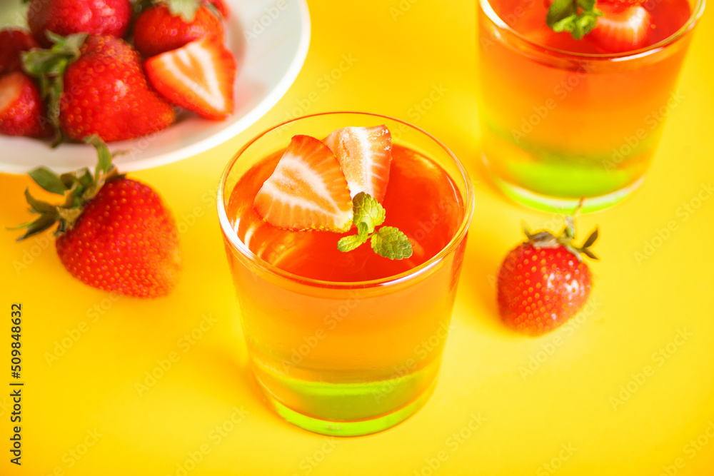 Glasses of tasty summer dessert layered colorful jelly with fresh strawberries Glasses of tasty summer dessert layered colorful jelly with fresh strawberries