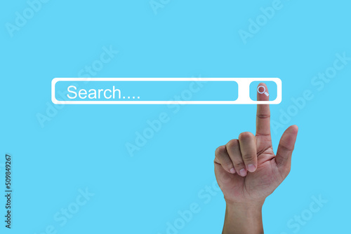 Searching Data Information Networking Concept with a businessman hand, on isolated on blue background.