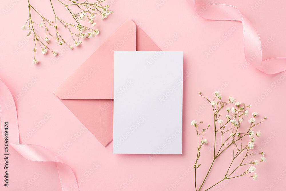 Birthday party invitation concept. Top view photo of pink envelope postal curly ribbons and white gypsophila flowers on isolated pastel pink background with copyspace