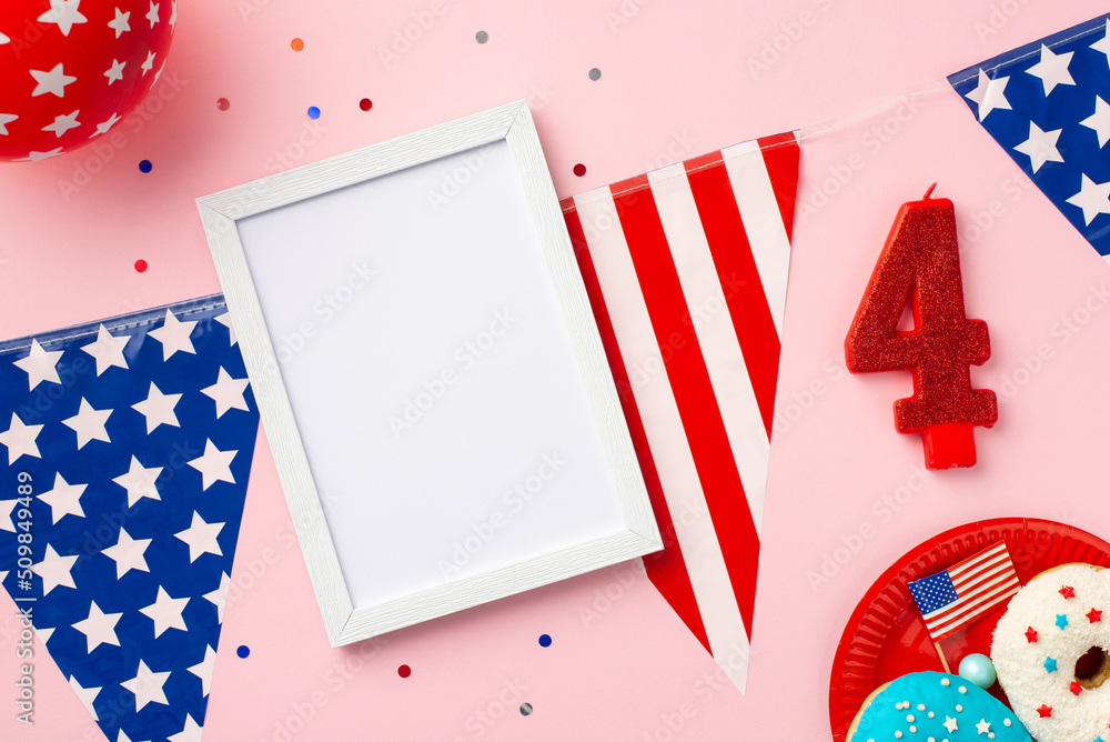 Obraz premium Fourth of July concept. Top view photo of photo frame over US national flag garland number 4 candle plate with glazed donuts balloon and confetti on isolated pastel pink background with copyspace