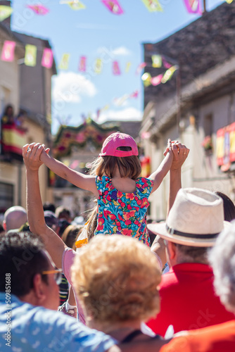 Girl on shoulders in a street of Bernardos