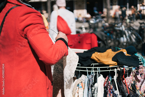 Taking clothes off the hanger at the flea market 