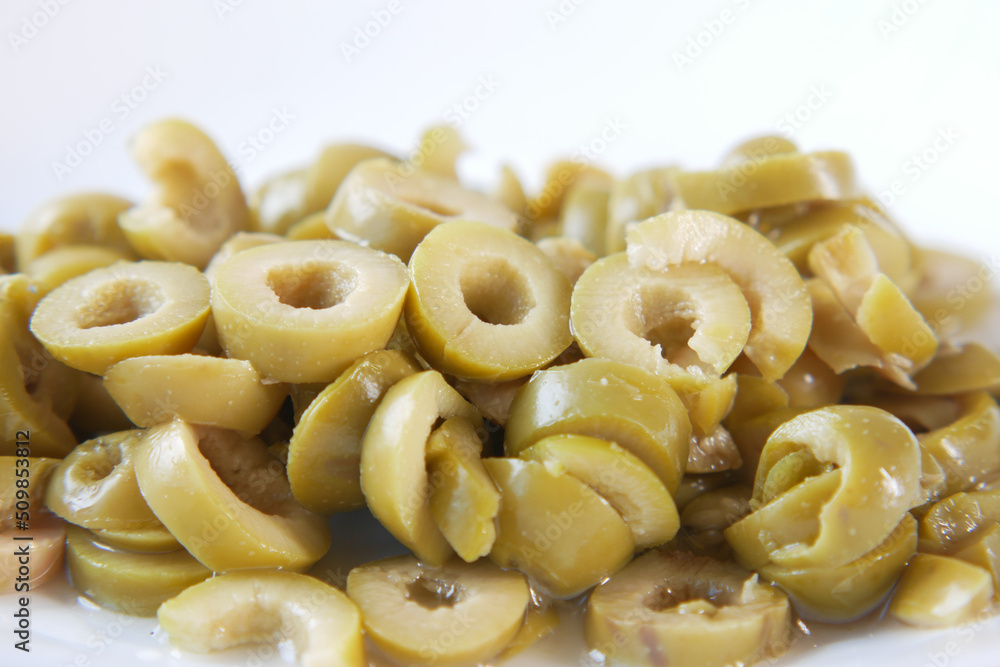 close up of slice of olives on white background close up of slice of olives on white background