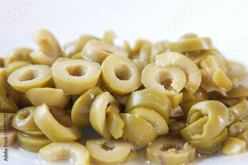  close up of slice of olives on white background 