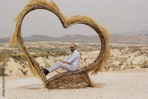 handsome man in a sunglasses kizilcukur valley in cappadocia, turkey	 photo