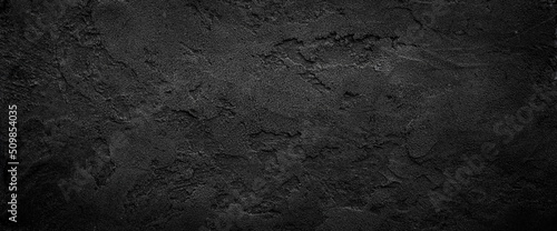 Obraz na plátně Black or dark gray rough grainy stone texture background