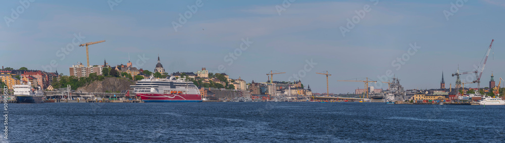 Panorama view with small passenger explorer and a cruise ship in the harbor a sunny summer day in Stockholm
