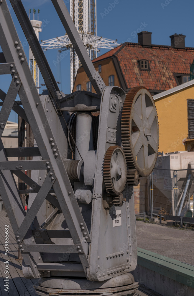 Old pier crane mechanism on a pier in a small harbor a sunny summer day in Stockholm Old pier crane mechanism on a pier in a small harbor a sunny summer day in Stockholm