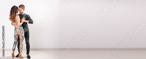 Banner couple dancing social latin dance bachata, merengue, salsa. Two elegance pose on white background copy space