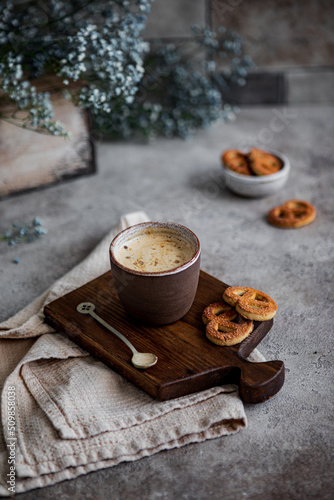 Kitchen still life with a cup of coffee on a board and a towel