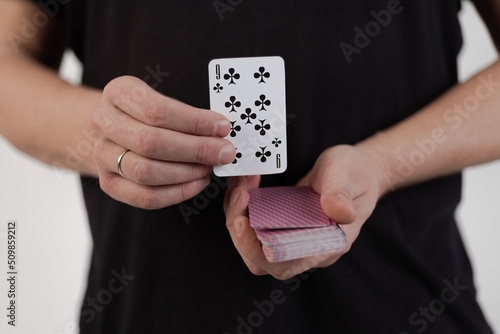 Male hands hold a deck of cards and show tricks.
The photographer is the author of the design of playing cards, which is written in the release of the property. photo