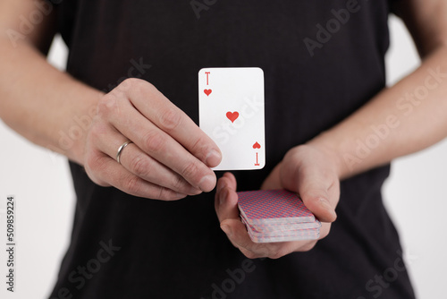 Male hands hold a deck of cards and show tricks.
The photographer is the author of the design of playing cards, which is written in the release of the property. photo