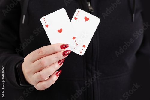 Female hands hold a deck of cards and show tricks.
The photographer is the author of the design of playing cards, which is written in the release of the property. photo