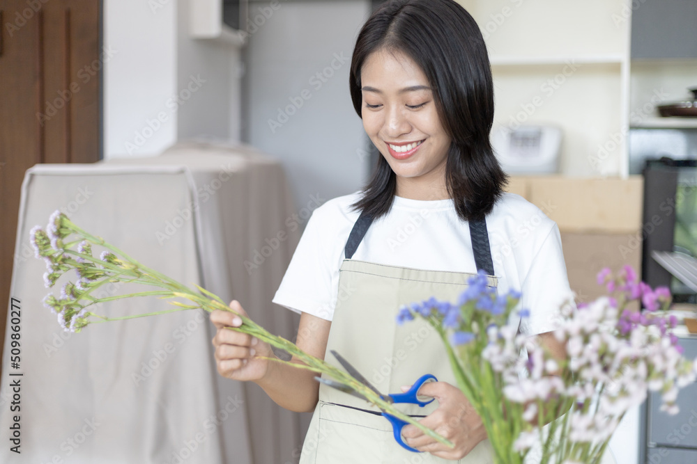 Bouquet, Asian woman puts a beautiful bouquet of colorful flowers in a vase to decorate the room, Freshen up and decorate the room, Decorations and arrangements, Flowers bunch, Arts and crafts. Bouquet, Asian woman puts a beautiful bouquet of colorful flowers in a vase to decorate the room, Freshen up and decorate the room, Decorations and arrangements, Flowers bunch, Arts and crafts.