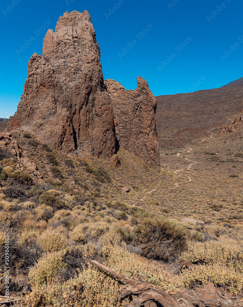 Fototapeta premium The Citadel rock formation and a walking path in Teide National Park. Roques de García trail. Volcano and volcanic landscape. Tenerife, Canary islands, Spain.