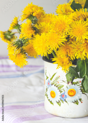 Yellow dandelions in a rustic vase