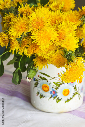 Yellow dandelions in a rustic vase