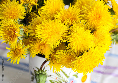 Yellow dandelions in a rustic vase
