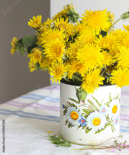 Yellow dandelions in a rustic vase