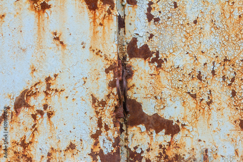 Rusty metal surface with blue cracked paint. Old rusty metal. Metal covered with rust.