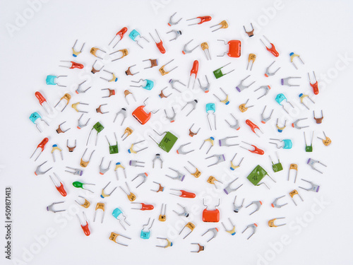 Wallpaper Mural Capacitors. Different type in different colors. Colorful small ceramic, metal, film capacitors. Green, blue, orange, red capacitors. On white background. Top view. Torontodigital.ca