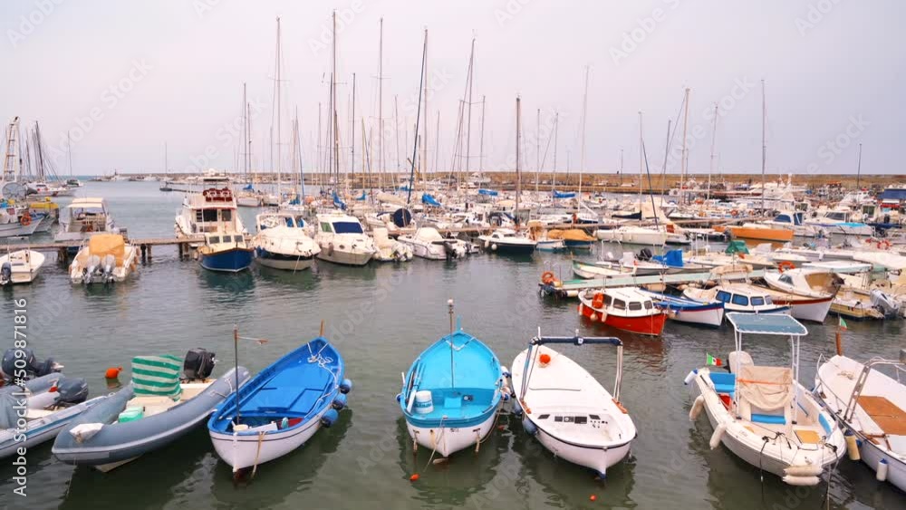 Mediterranean sea port with multiple moored yachts and boats in Sanremo, Italy. Cloudy sky Mediterranean sea port with multiple moored yachts and boats in Sanremo, Italy. Cloudy sky