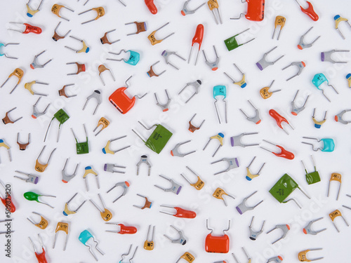 Wallpaper Mural Capacitors. Different type in different colors. Colorful small ceramic, metal, film capacitors. Green, blue, orange, red capacitors. On white background. Top view close-up. Torontodigital.ca