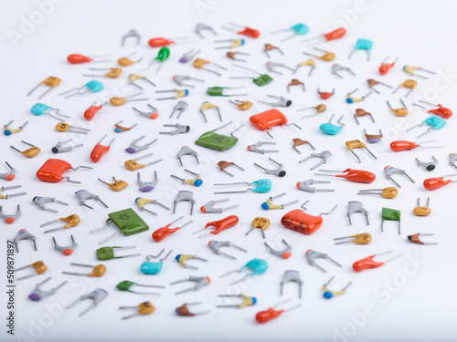 Wallpaper Mural Capacitors. Different type in different colors. Colorful small ceramic, metal, film capacitors. Green, blue, orange, red capacitors. On white background. Perspective view close-up. Torontodigital.ca