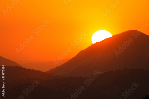 Beautiful orange golden sunset in mountains of California