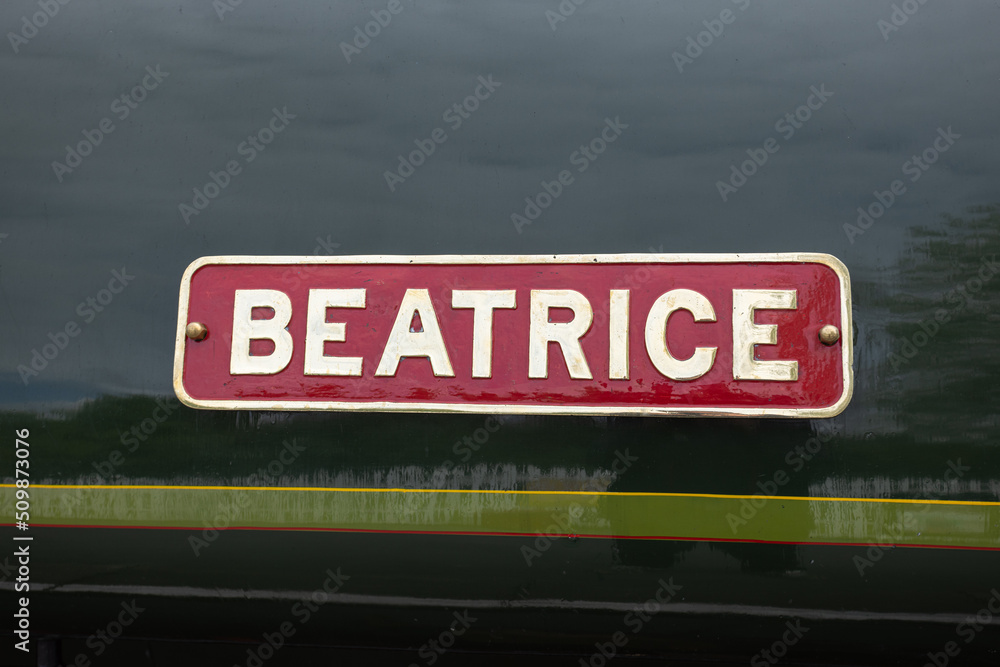 Red sign with white letters saying Beatrice on side of London North Western Railway steam train, Bolton Abbey Steam Railway, UK Red sign with white letters saying Beatrice on side of London North Western Railway steam train, Bolton Abbey Steam Railway, UK