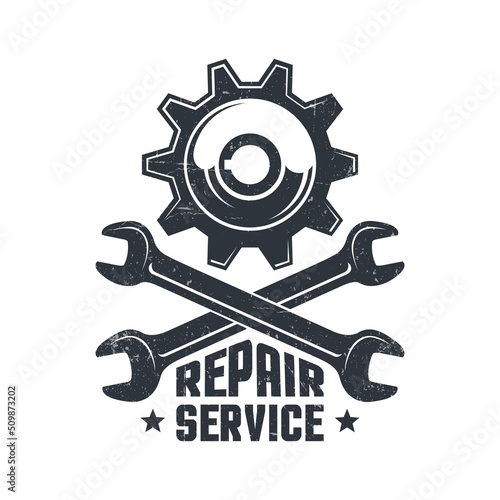 Mechanical repair workshop - retro logo with gear and wrenches. Spanner and gear wheel - vintage emblem. photo