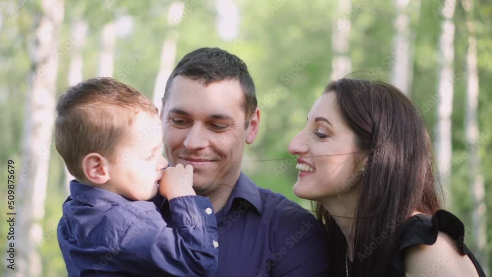 Pregnant woman with husband and son. A young family is waiting for the birth of their second child. Wife with husband and child relaxing in nature in a city park. Pregnant woman with husband and son. A young family is waiting for the birth of their second child. Wife with husband and child relaxing in nature in a city park.