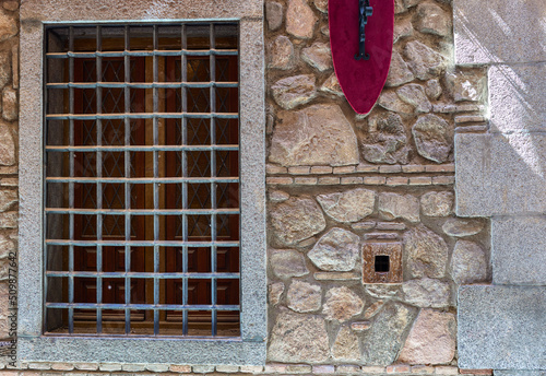 The smallest window of the world on the principal facade of the Cason de los Lopez de Toledo Palace. Toledo, Castilla La Mancha, Spain. photo