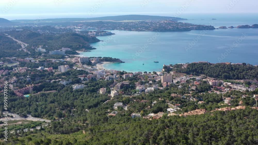 Aerial orbiting shot flying around Peguera from mountain side with hotels and beaches. Sea in background. Mallorca, Balearic Islands, Spain Aerial orbiting shot flying around Peguera from mountain side with hotels and beaches. Sea in background. Mallorca, Balearic Islands, Spain